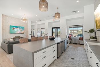 the kitchen is open to the living room and dining room at The Maddox Luxury Apartment Homes, Buckeye, AZ